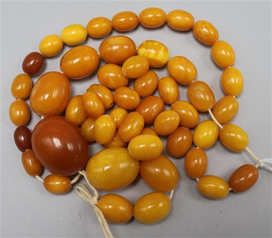 A single strand graduated amber bead necklace, including some loose beads,
